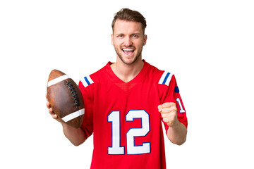 Young caucasian man playing rugby over isolated chroma key background celebrating a victory in winner position