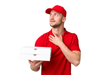 Pizza delivery man with work uniform picking up pizza boxes over isolated chroma key background...