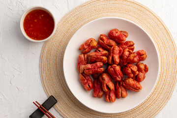 Air fryer thai red sausage,Crispy Chicken Cocktail Sausage in white plate.with sweet chilli dipping sauce.healthy cooking on junk food.Top view.