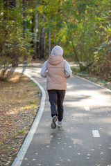 A person is running on a path in the woods