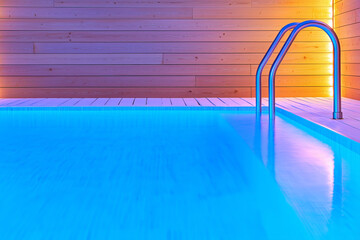 Obraz premium Modern indoor swimming pool with blue lights and wooden walls during evening relaxation time
