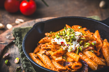 Pasta rigatoni with radicchio, pistachios, ricotta and chili