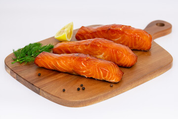 Deliciously Grilled Salmon Fillets Arranged Beautifully on a Rustic Wooden Board
