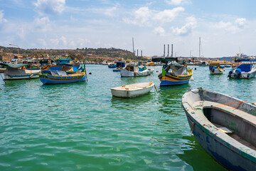 Fototapeta premium View of Marsaxlokk harbour with traditional colourful fishing boats in Malta