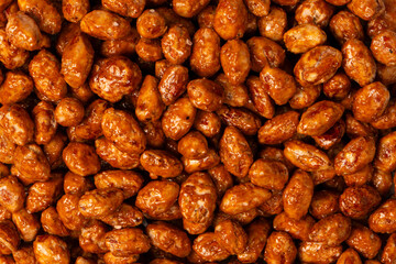 Tasty sweet roasted peanuts as a background.