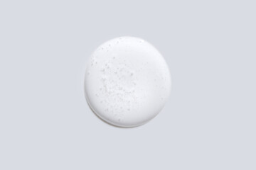 Minimalistic circular white stone with textured surface on gray background for design and art trend concepts