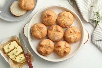 Flat lay composition with homemade tasty buns and butter on white table