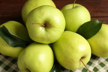 Fresh green apples on wooden table, closeup