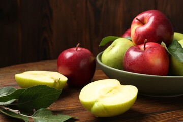 Fresh red and green apples on wooden table