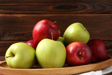 Fresh red and green apples on wooden table, closeup