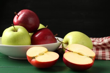 Fresh ripe apples on green wooden table