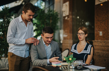 Business team collaborating in an outdoor meeting, focusing on marketing and sales strategies. They are examining reports and discussing business growth plans.