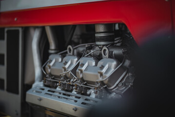 Old tractor diesel engine on a display under the motor cover.
