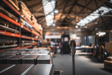 Finished product on a palets and raw material on shelves in a factory.