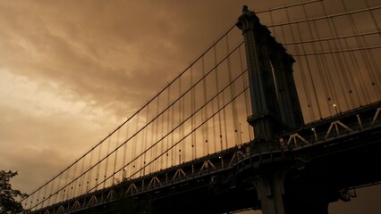 Manhattan Bridge to Brooklyn Dumbo. New York City symbol, USA travel destination. Architecture of United States of America, tourist landmark. Cables, evening sunset dramatic cloudy sky before rain.
