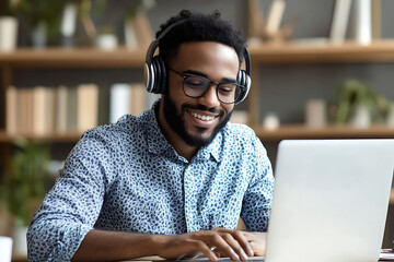 A young man smiling in front of laptop. Business owner starter concept