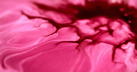 Ink spill. Wet glitter flow. Defocused magenta pink red color shimmering marble texture paint...