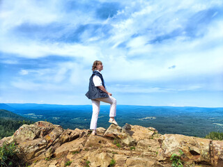 Adventures on a journey. A blogger poses, takes a selfie or podcast in the mountains with a magnificent view