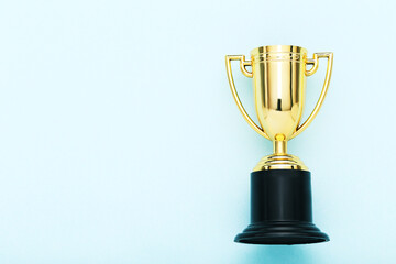 Golden trophy cup on blue background