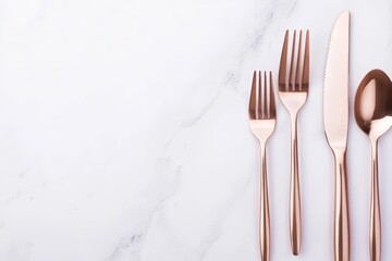 Luxurious rose gold cutlery set displayed on a marble surface, reflecting style and elegance, ideal for a modern, high-end table setting