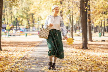 Autumn portrait of a young beautiful blonde woman