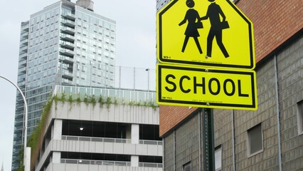 School zone yellow road sign, pedestrian crossing. Children safety on street, New York City. Transport and education symbol, USA . Traffic roadsign in Queens, Long Island, Hunters point.