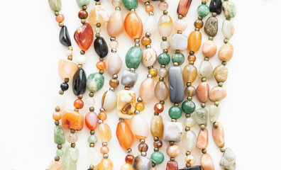 Set of Colorful Gemstone Necklaces Close-up– Agate and Quartz Stones Flatlay on White Background