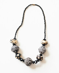 Tribal Glass and Batik Painted Bone Bead Necklace – Flatlay on White Background with Soft Lighting