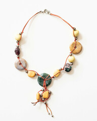 Fototapeta premium Tribal Style Gemstone and Quartz Necklace – Flatlay on White Background with Soft Lighting