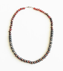 Obraz premium Colorful Glass Bead Necklace – Boho Style Jewelry Flatlay on White Background