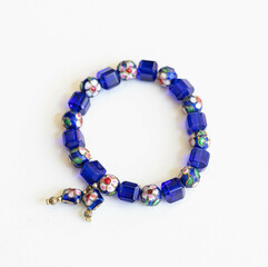 Boho Blue Glass and Enameled Metal Bead Bracelet &ndash; Flatlay on White Background