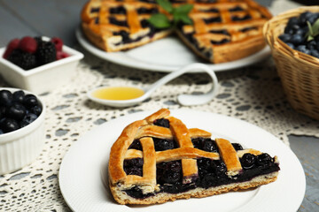 Piece of tasty homemade pie with blueberries on gray table, closeup