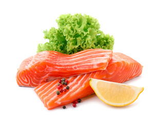 Pieces of fresh salmon, peppercorns, lemon and lettuce isolated on white