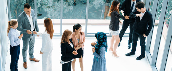 Many business people gathering in modern office building for business conference in the city. Businessmen and businesswomen communication and human resources concept. uds