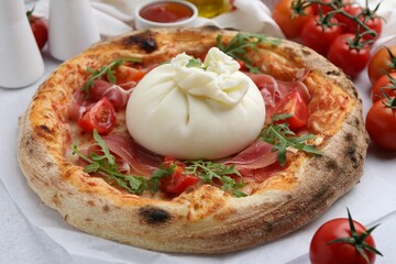 Delicious pizza with burrata cheese served on table, closeup