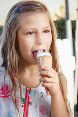 A happy child with ice cream in hands in nature travel