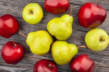 pears apples on wood background top view