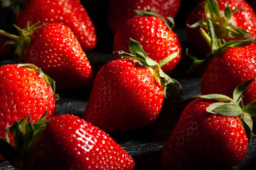 strawberries on black wood background