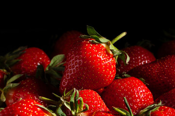 strawberries heap on black background