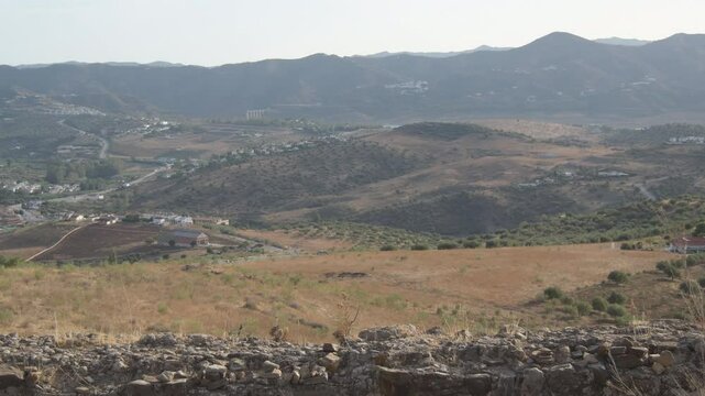Rests of ancient wall of a fortress at sunset, Alcaucin, Spain