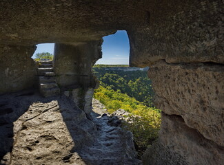 Russia, the Republic of Crimea. A view from inside the dilapidated stone room of the famous cave city of Mangup-Kale of the 5th century in the Bakhchisarai district.