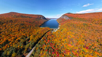 Epic Wide Fall Foliage Over Lake Willoughby Vermont Autumn Season Aerial Drone View. Bright Sun Blue Sky October New England