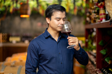 Elegant Man Smelling Red Wine in Luxury Wine Cellar – Tasting Experience