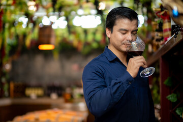 Businessman Enjoying Fine Wine in Cellar – Smiling and Tasting in Wine Storage Room