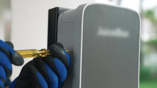 Qualified technician install home EV charging station, providing maintenance service for electric vehicle's battery charging platform at home. EV car technology for residential utilization. Fastidious