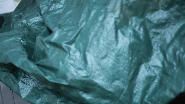 Winterizing series - Man places tarp cover from outdoor air conditioner unit - CU