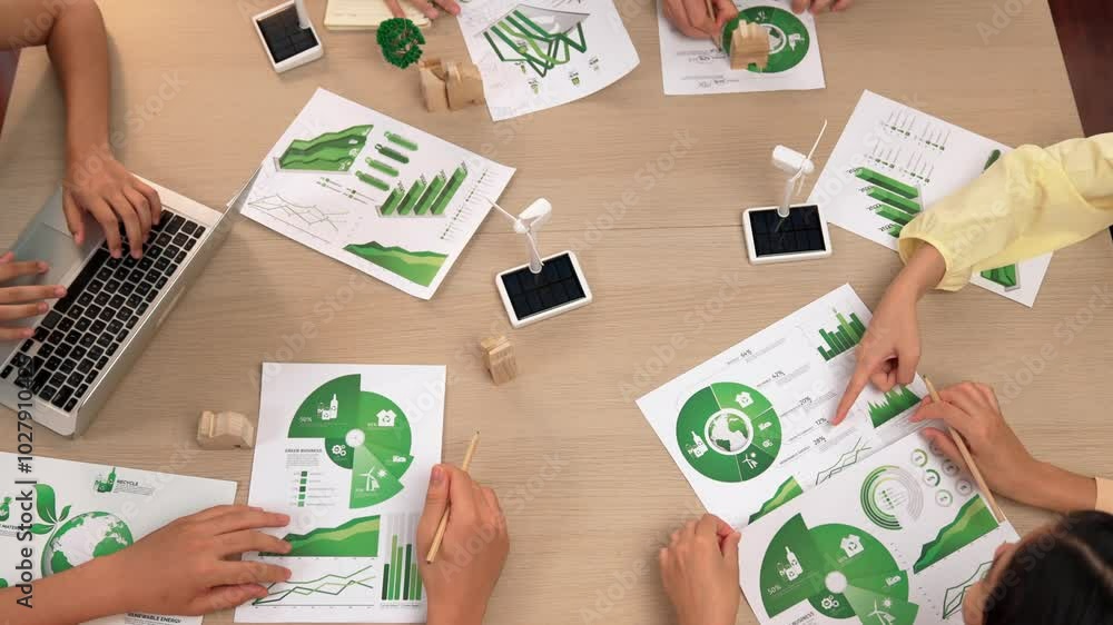 Poster excellent business team discussing on eco house project at meeting table with windmill design model 