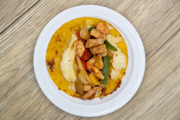 Overhead view of grilled shirmp taco gobernador covered with onion, cilantro, and cheese served on a tortilla for lunch