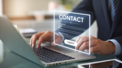 Professional man submitting contact information on a laptop.