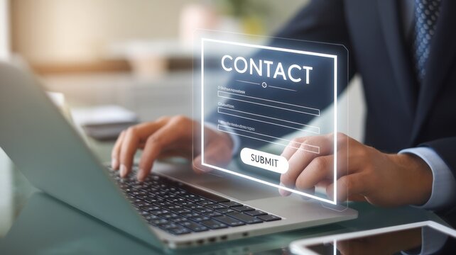 Professional man submitting contact information on a laptop.